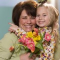 Child giving mother flowers