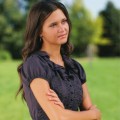 modestly dressed young woman pondering