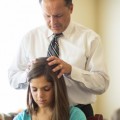 Young woman receiving priesthood blessing
