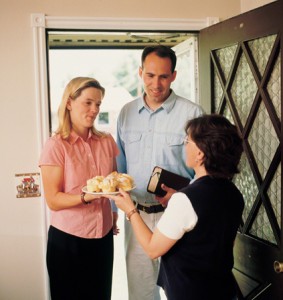 couple bringing a treat to a woman.