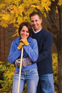 couple raking leaves