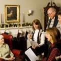 singing Christmas carols to an older woman