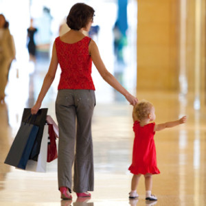 Child pulling mom in mall
