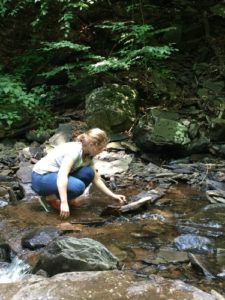 Teen laying stones in a design