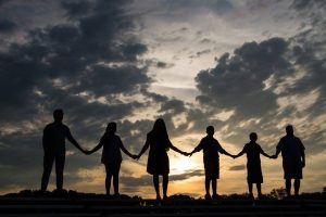 family holding hands in the sunset