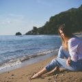 woman beach alone sad