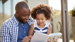 father reading to daughter