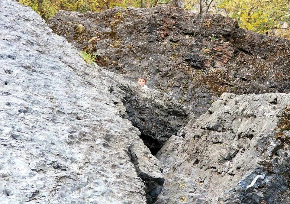 boy climbing boulders