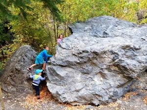 Jake, Bratcher, and Emilia climbing rocks