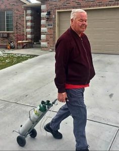 COVID oxygen tank man walking